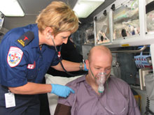 man being treated by a Paramedic in an Ambulance