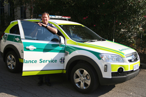 Paramedics with ambulance sedan